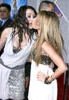 Miley Cyrus and Ashley Tisdale kissing at 'Hannah Montana / Miley Cyrus: Best of Both Worlds Concert Tour' Film Premiere, Hollywood, on Jan 17