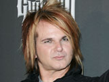 Poison drummer arrested on rape warrant