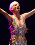Sarah Harding performing with Girls Aloud in concert at Newmarket Racecourse