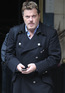 Eddie Izzard waiting for a taxi outside the Dorchester Hotel, London