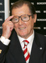Roger Moore signing his autobiography 'My Word is My Bond'