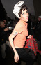 Amy Winehouse lunges at a photographer as she leaves her London home