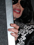 Michael Jackson peeps out of his minbus in London