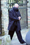 Boy George leaving his London home with a scarf covering his face