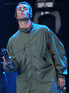 Tamborine maestro Liam Gallagher on stage with Oasis during their hometown gig at Heaton Park, Manchester
