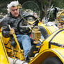 Jay Leno out and about in his antique yellow 1913 Mercer Raceabout in Santa Monica, California