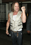 Mickey Rourke marks three crosses on his hand as he leaves the London Wellington Club
